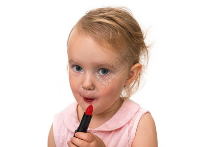 可爱的小女孩在化妆和涂口红年图片