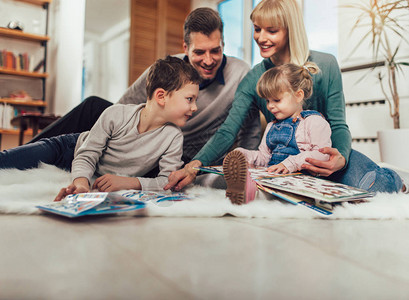 幸福的家庭在家里客厅的地板上玩图片
