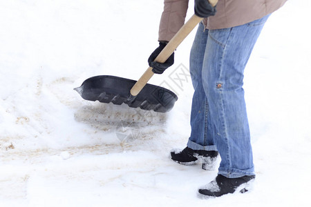 冬天下了很多雪一个年轻女孩清洁工以做大图片