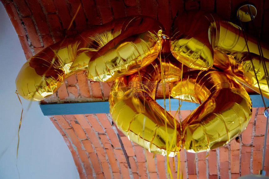 室内高砖天花板附近的金色气球图片