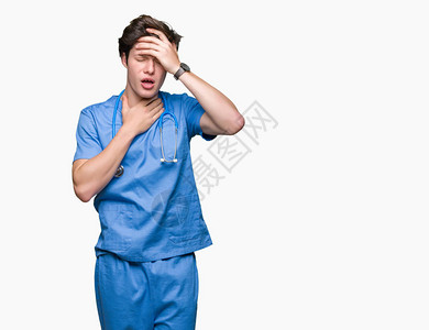 身穿医疗制服的年轻医生在与世隔绝的背景下触摸额头以生病和发烧流感和图片