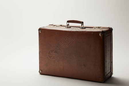 灰色背景上的复古皮革棕色手提箱图片