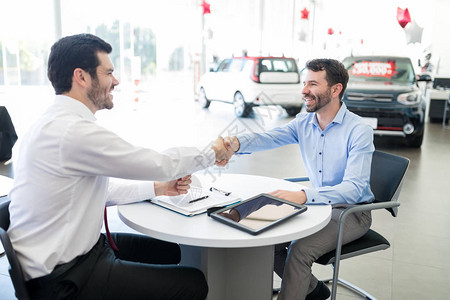 年中成人买卖双方在对汽车经销商握手时图片