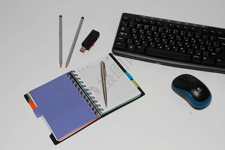 白色背景的计算机键盘不同文具图片