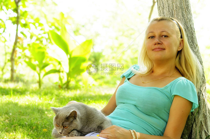 女孩和一只灰猫睡在阳光明媚的图片