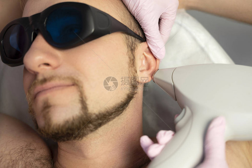 女医生美容学家用激光触摸器从男人身上摘除头发图片
