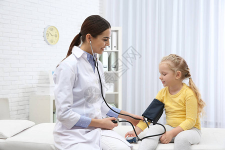 在医院看医生的小女孩测量血压和检查脉搏图片
