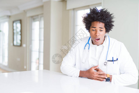 在诊所的非裔美国医生因消化不良而胃痛图片