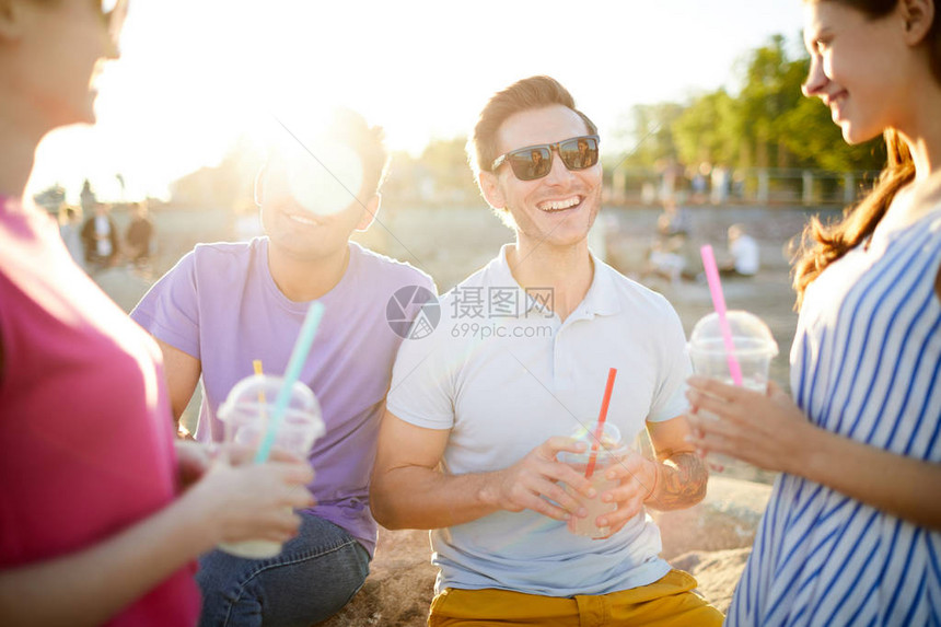 在夏日野餐期间和朋友聊天时笑着图片