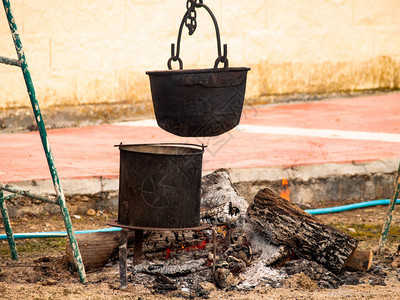 街上篝火上挂着生锈的旧铁罐背景图片