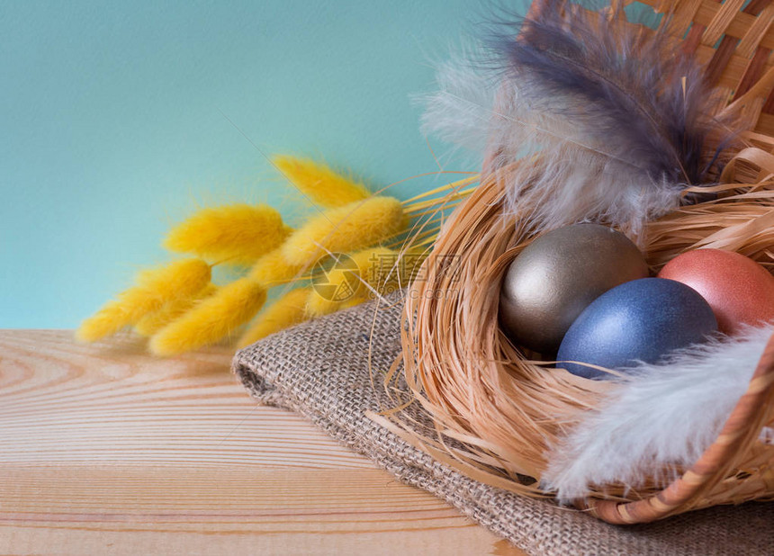 复活节背景与复活节彩蛋在木制背景的篮子里装饰着羽毛和干花带有复制空间的前视图自然风格传统俄罗图片