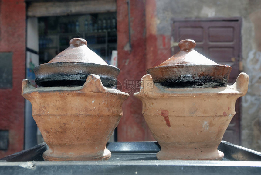 在摩洛哥传统陶瓷塔吉尼菜盘中制作食品的马图片