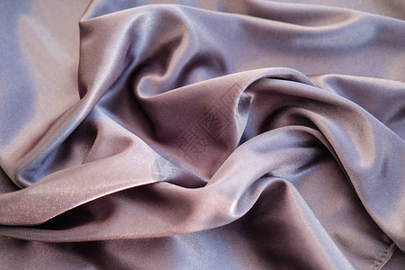 紫色银织物布料铺设了波浪图片