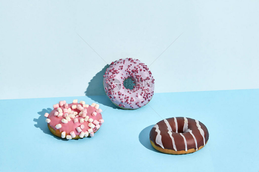 在焦糖和巧克力糖衣的三个甜可口甜圈图片