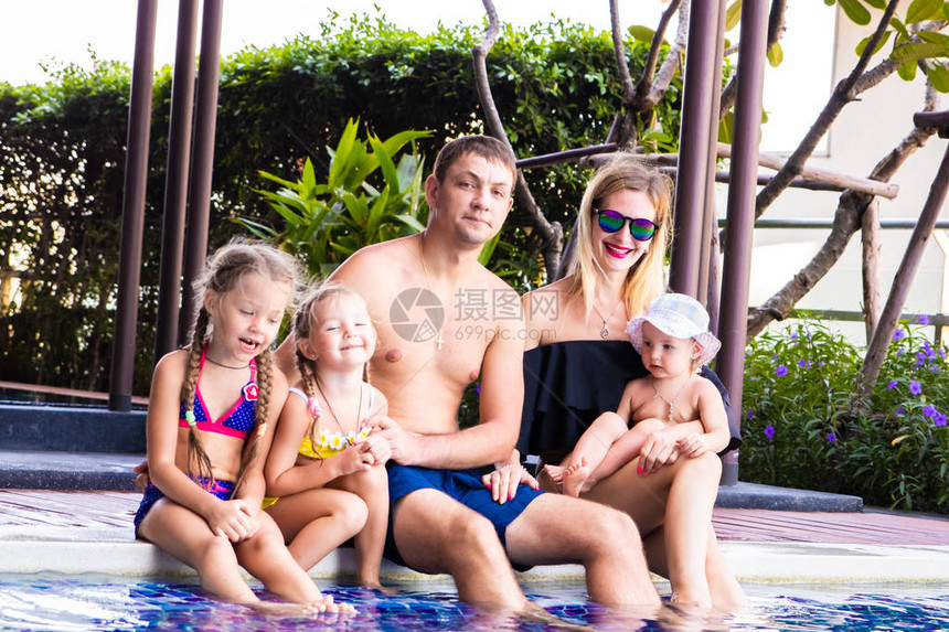 一个大家庭坐在别墅的游泳池旁妈爸和三个女儿一个幸福的家庭图片