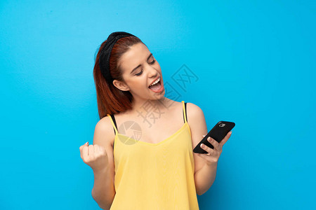 蓝背景的年轻红发女青年手机图片
