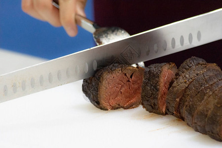 烤牛肉和切片厨师手切烤牛肉图片