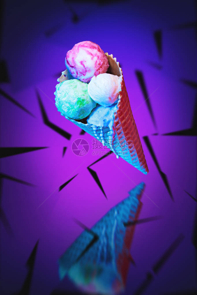 华夫饼锥中的冰淇淋漂浮在霓虹紫蓝色抽图片