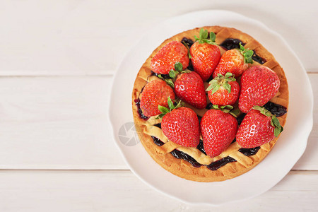 草莓蛋糕和白色木制背景上的甜点图片