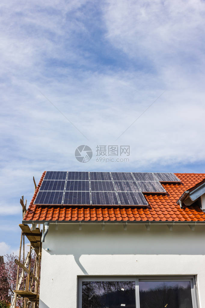 在南德部乡村春季下午的屋顶上配有太阳能电池板的图片