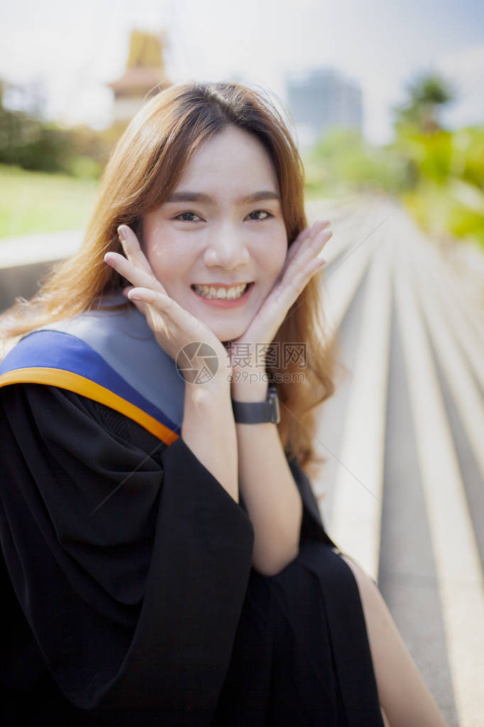 身穿大学毕业西装带着快乐的情绪微笑图片