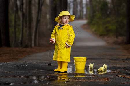 一个小孩在雨中玩耍而小妞图片