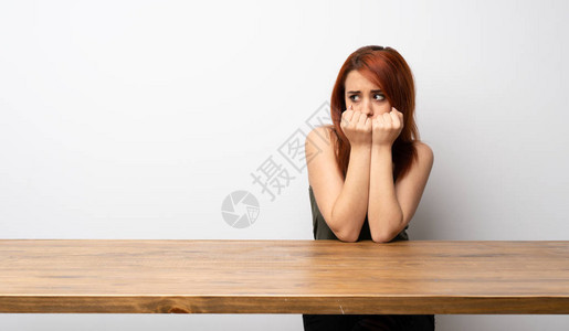 年轻的红发女青年在办公桌紧张图片