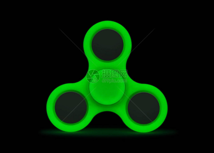 在黑暗中发光孤立在白色背景上的绿色指尖陀螺减压玩具图片