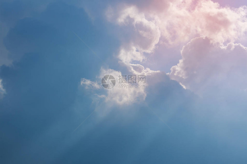 阳光透过云层在清澈的蓝天背景下图片