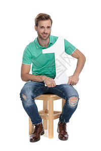 很酷的家伙坐在白色背景的木椅上拿着第一号牌图片