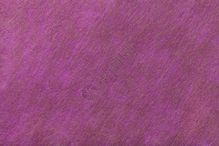 深紫色背景的结构与毛毡织物的棕色斑点图片