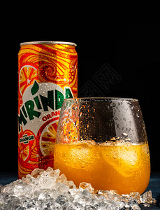 美琳达橙玻璃和罐头Mirinda是一个软饮料品牌高清图片