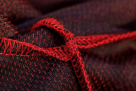 红色运动服封闭顶端视图内部接缝和关节可透气的编织服装背景图片