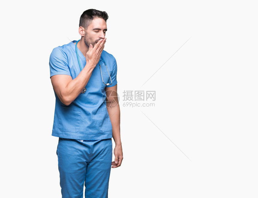英俊的年轻医生外科医生在孤立的背景下无聊地打着哈欠累了用手捂住嘴图片