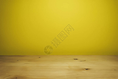 美丽的白色木桌和黄色的墙壁背景图片