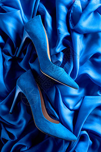 蓝色女人的紧身鞋在丝绸背图片