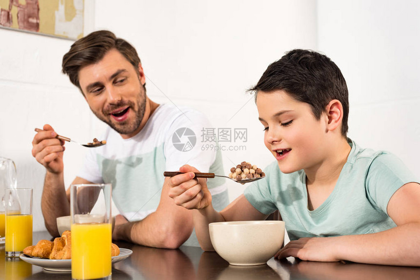 父亲和儿子笑着在厨图片