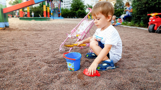 3岁的可爱小男孩在公园儿童游乐场玩耍图片