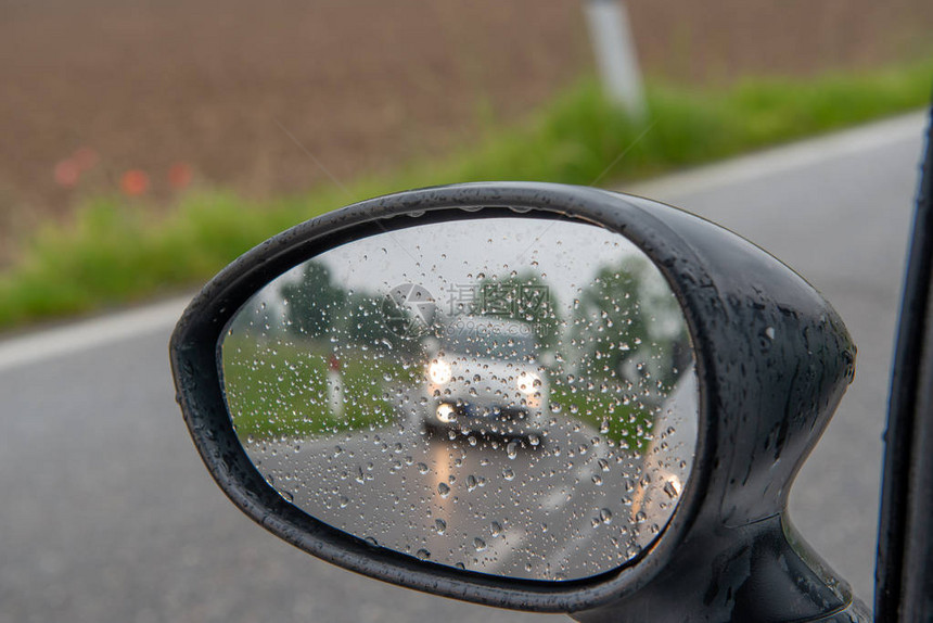 雨中行驶的汽车后视镜图片