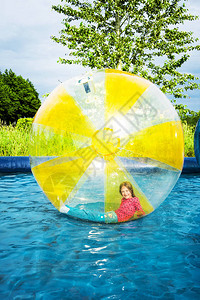 年轻女孩躺在浮水行走的球体图片