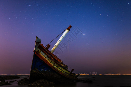 夜间在海滩上沉船或失事的船图片
