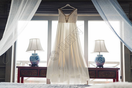 婚礼室内在酒店向新娘收费婚纱摄影新娘礼服挂在窗边loft风格图片