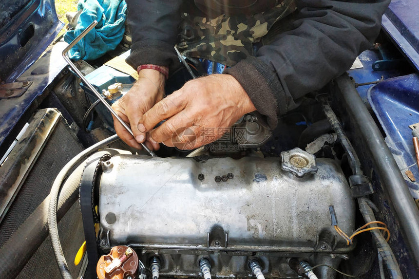 汽车修理工打开了一辆旧车的发动机盖图片