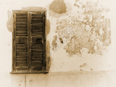 旧破裂房屋墙壁的褪色棕褐色图像图片