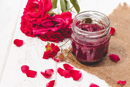 光背景的玻璃罐中的玫瑰花瓣果酱鲜花健康食物图片