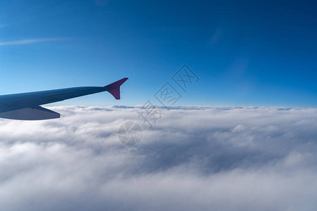 从飞机窗口看到飞机翼侧面的光影高清图片