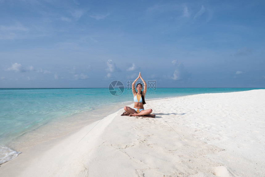 冥想在宁静的海滩冥想的瑜伽女人图片
