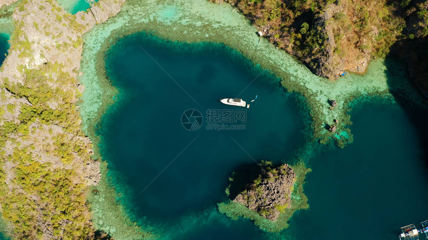 空中无人驾驶快艇与游客在美丽的泻湖热带景观热带岛屿上被岩石包围的蓝色泻湖海景图片