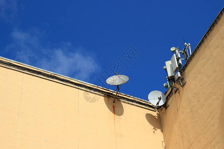 房顶上的电信视抛物面天线和手机天线图片
