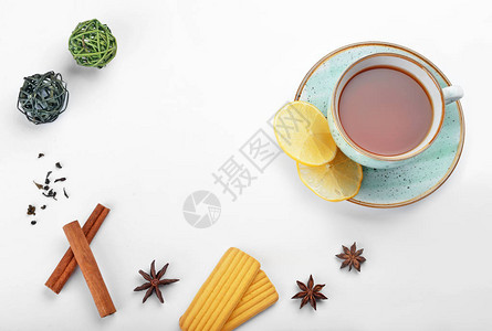 一杯美味的茶配上白色背景的香料和饼干图片